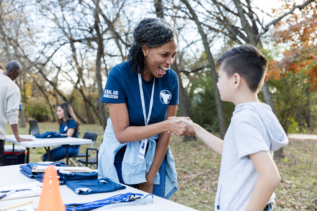 Volunteer coordinator greets young volunteer